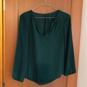Dark green blouse with gold and embellishments.